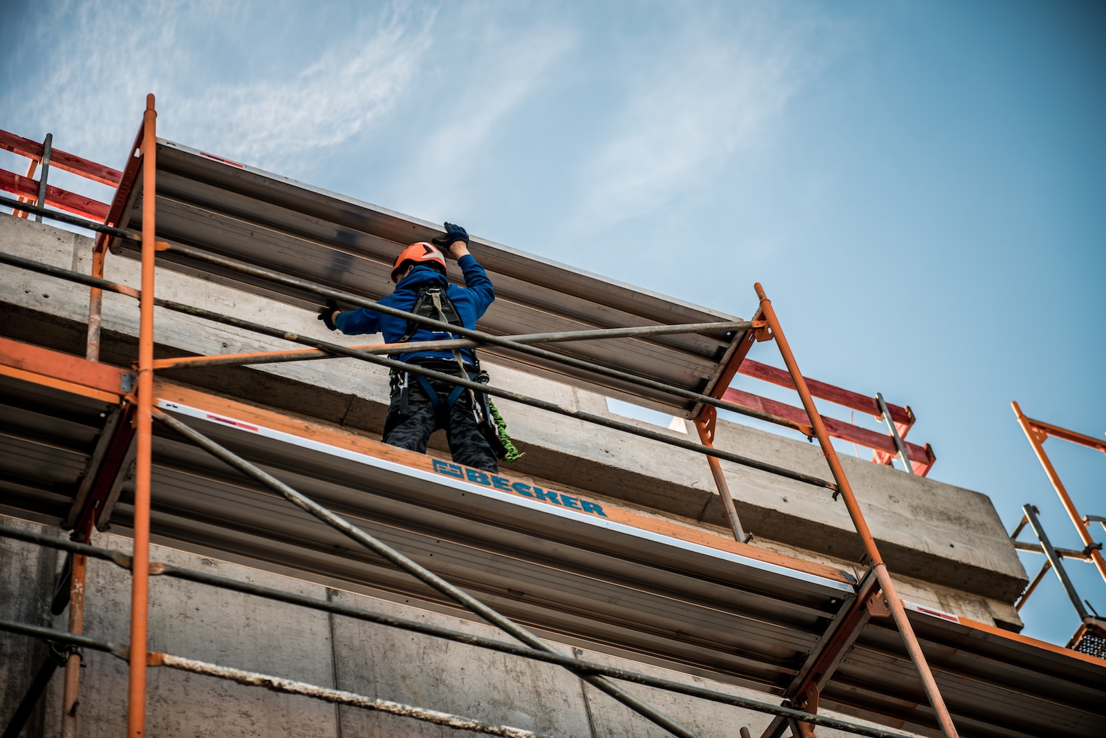 a man on a scaffold working on a building
